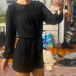 Black long sleeve romper. Ruffled shoulders. Adjustable waist tie